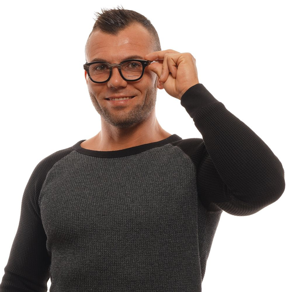Man wearing Ermenegildo Zegna Black Horn Glasses (Frames) with full-rim square style, adjusting glasses.
