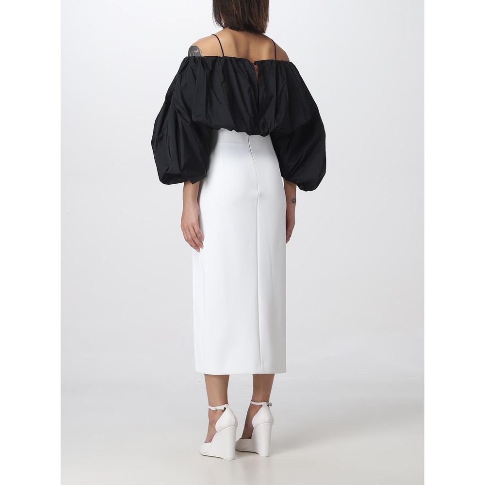 Woman wearing PINKO White Polyester Midi Skirt with thigh slit, back view, size 42, styled with black off-shoulder top and white heels
