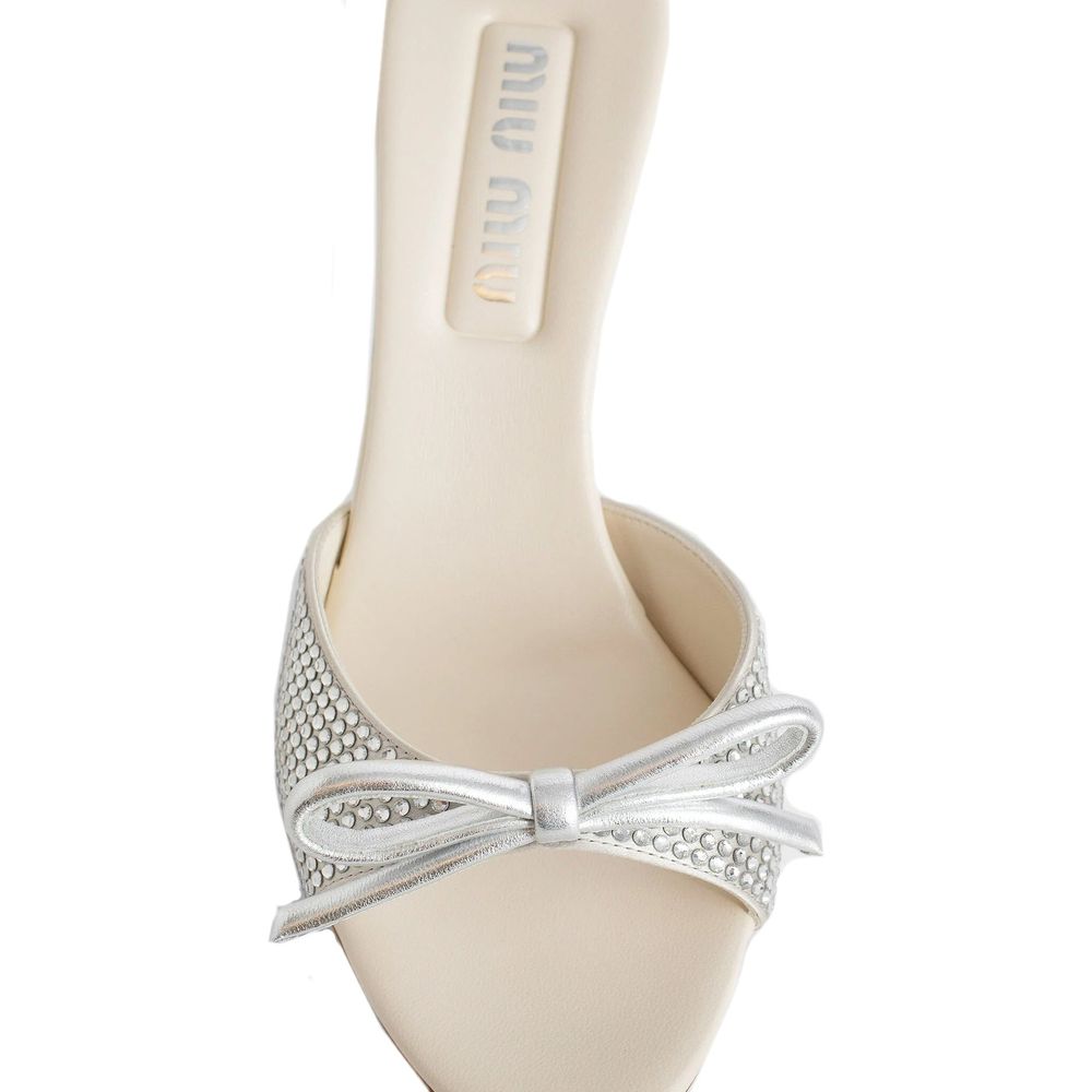 Miu Miu Silver Silk Mules with crystal embellishments, branded insole, and top bow detail, showcasing luxury women's footwear design.