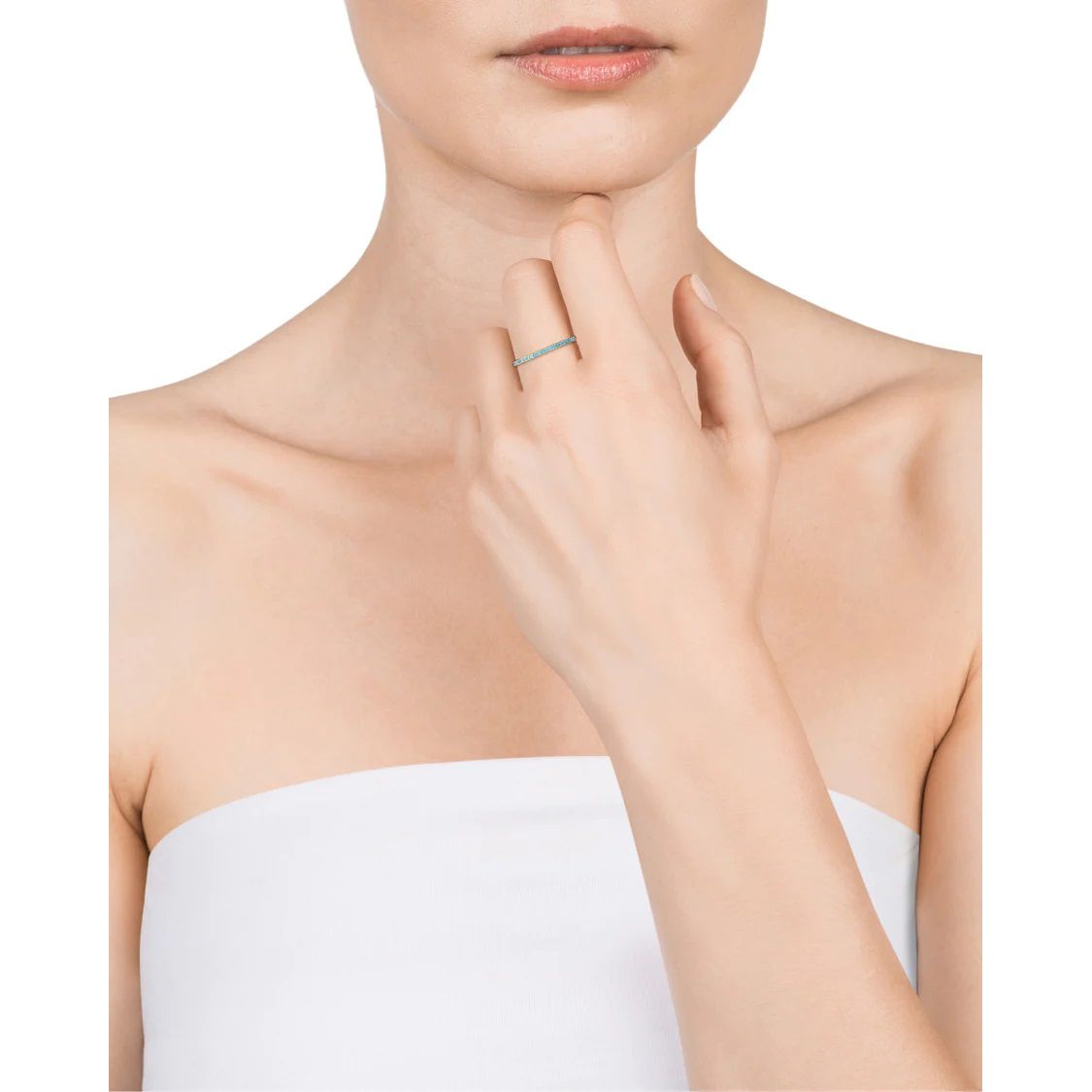 Woman wearing elegant thin ring with minimalist design, showcasing a stylish fashion statement.