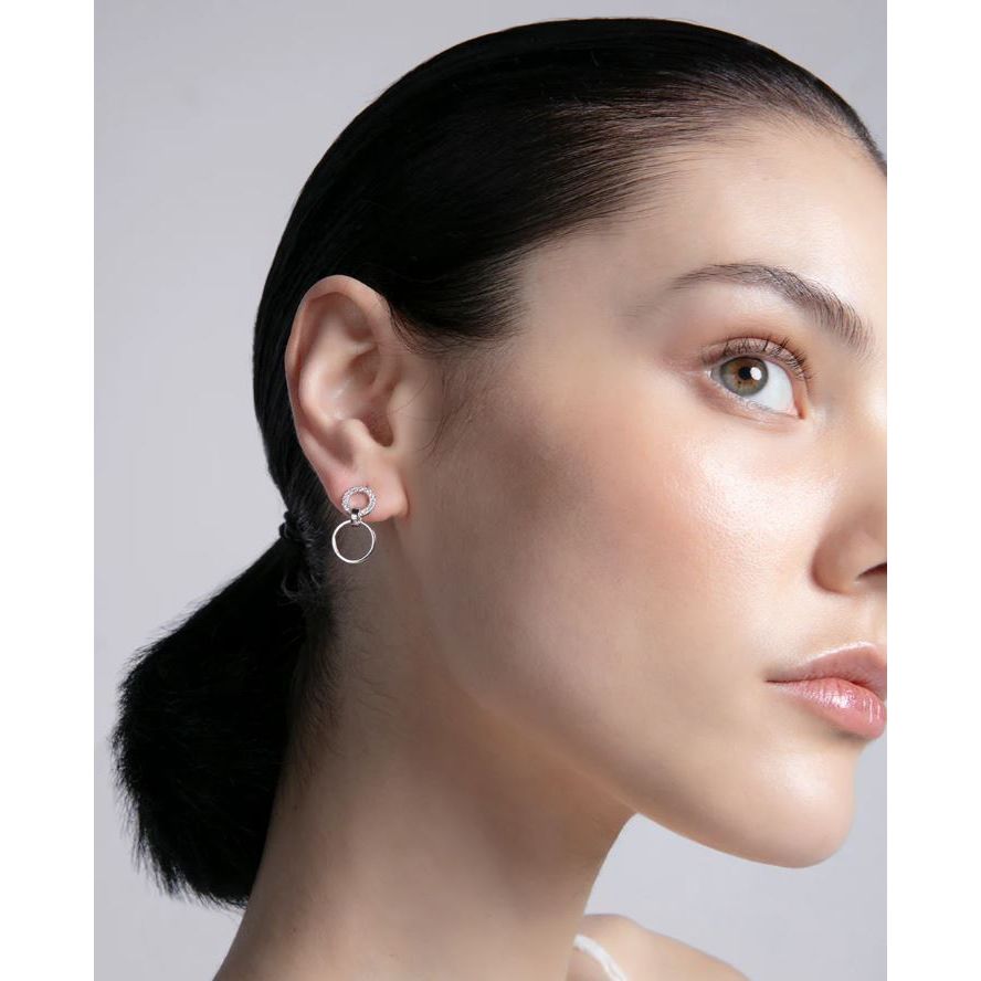 Woman wearing VICEROY JEWELS Mod. 13214E000-30 earrings, lady's silver jewelry, featuring multifunctional design and quartz analog movement.