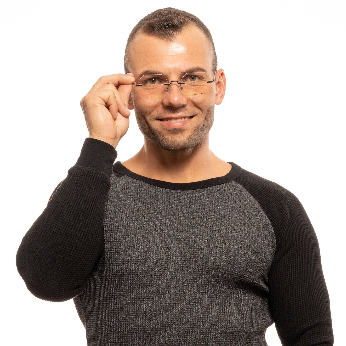 Man wearing Yohji Yamamoto Gray Metal Glasses (Frames) with a warm smile, showcasing rimless, round style and grey color.