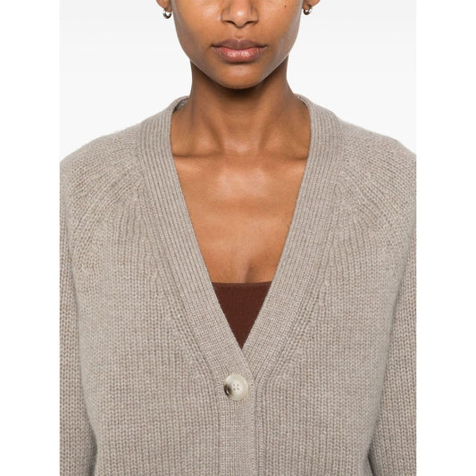 Woman wearing SOFT GOAT Sweaters Light Grey cashmere V-neck cardigan with taupe grey front button fastening and ribbed trim.
