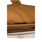Internal view of Coach Tabby 20 leather crossbody bag showing multifunctional pockets and snap closure