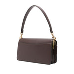 Coach Tabby 26 leather shoulder bag in earth brown, featuring pebbled texture, detachable strap, logo plaque, and slip pocket.