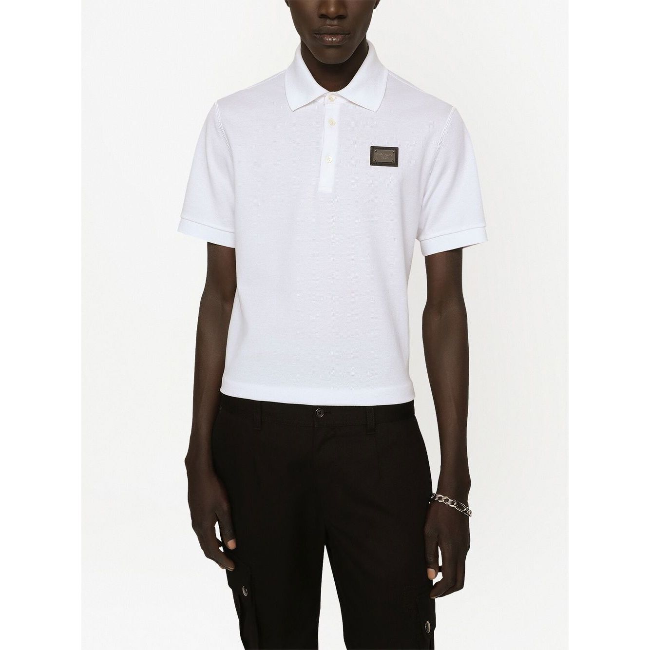 Dolce & Gabbana Logo cotton polo shirt in white, featuring a logo plaque, polo collar, short sleeves, and straight hem, worn by model.