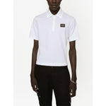 Dolce & Gabbana Logo cotton polo shirt in white, featuring a logo plaque, polo collar, short sleeves, and straight hem, worn by model.
