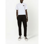 Dolce & Gabbana Logo cotton polo shirt in white, featuring a piqué weave, logo plaque, polo collar, short sleeves, and straight hem.