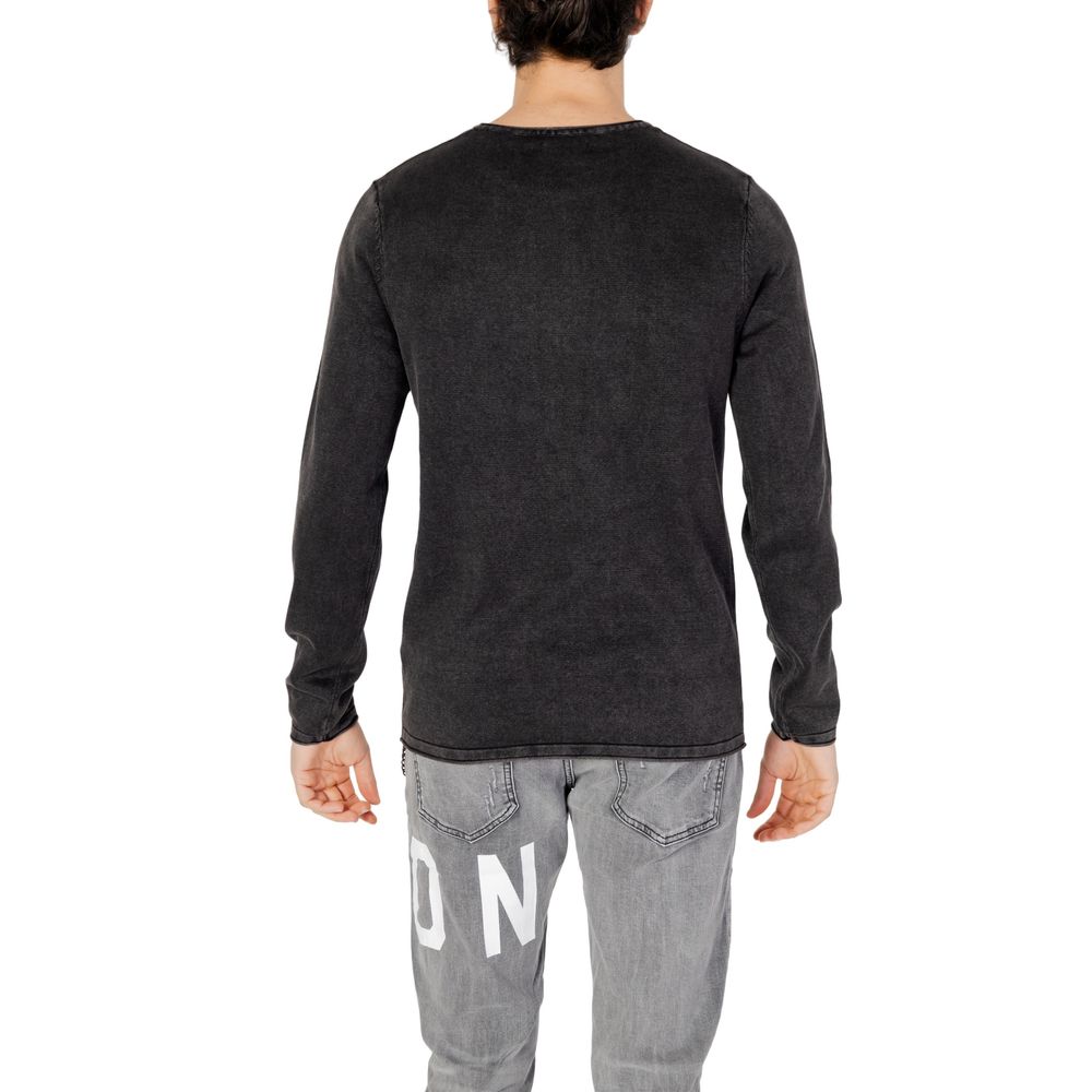 Back view of Jack Jones Black Cotton Sweatshirt on male model wearing gray jeans, showcasing long sleeves and crew neck design.