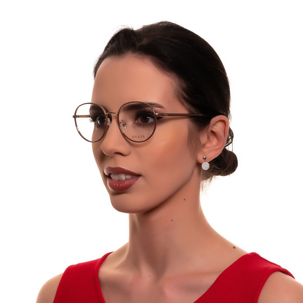 Woman wearing Guess Gold Women Glasses Frame, gold metal full-rim, panto style, with demo plastic lenses, spring hinge and branded case.