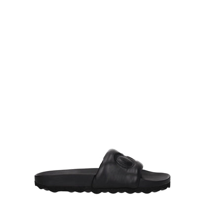 Off-White Black Leather Slippers featuring rubber sole and front logo, designed in sleek black leather, casual style with low, flat heel.
