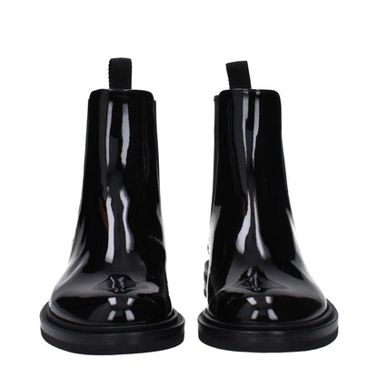 Dolce & Gabbana Black Leather Ankle Boots in patent leather with silver details and rubber sole, stylish low flat heel.