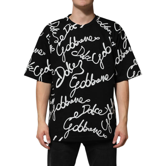 Man wearing Dolce & Gabbana Black Logo Print Cotton Crew Neck T-shirt with short sleeves and branded design, regular fit, made in Italy.