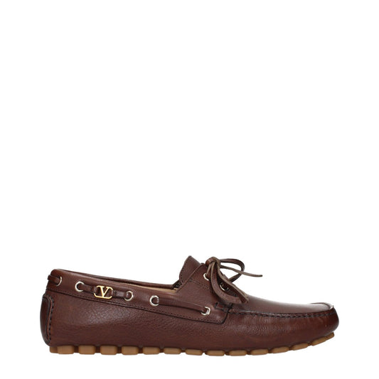 Valentino Garavani Brown Leather Slip-On Loafers with vintage and aged effect, lace-up closure, and a low flat heel.