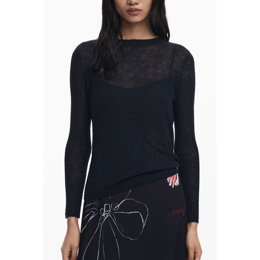 Woman wearing Desigual Black Polyester Women Dress with long sleeves and abstract design.