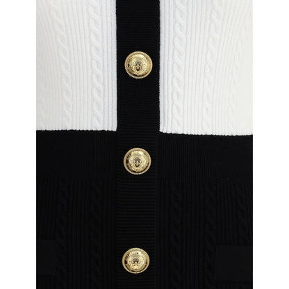 Close-up of embossed buttons on Balmain Multicolor Viscose Casual Dress with braided pattern and V-neckline.