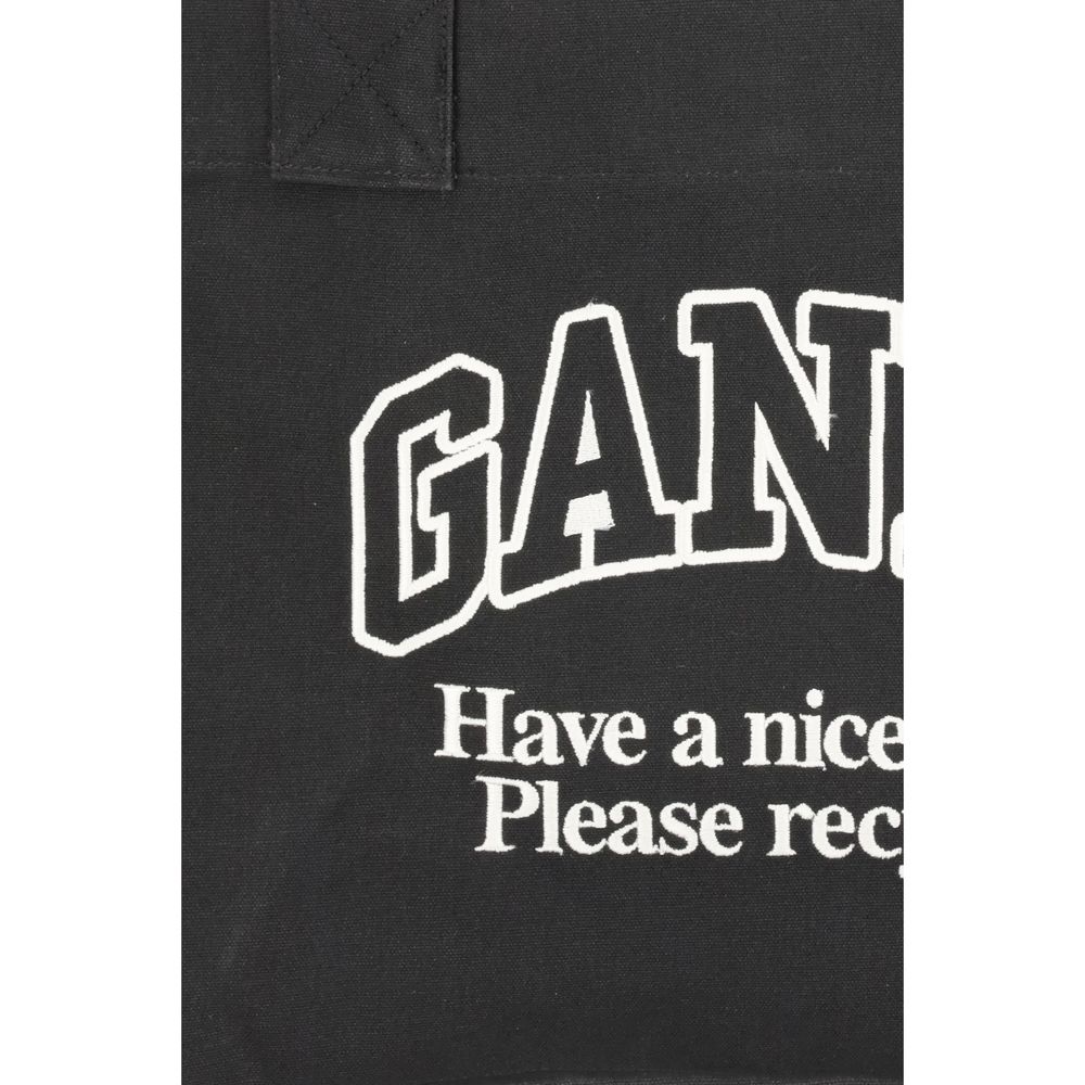 Ganni Black Cotton Shoulder Bag with logo and "Have a nice day! Please recycle" message on black canvas.