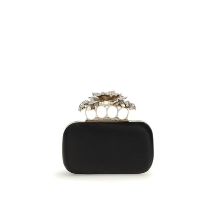 Alexander McQueen Black Silk Clutch Bag with crystal carnation knuckle handle and gold chain, elegant AW25 accessory.