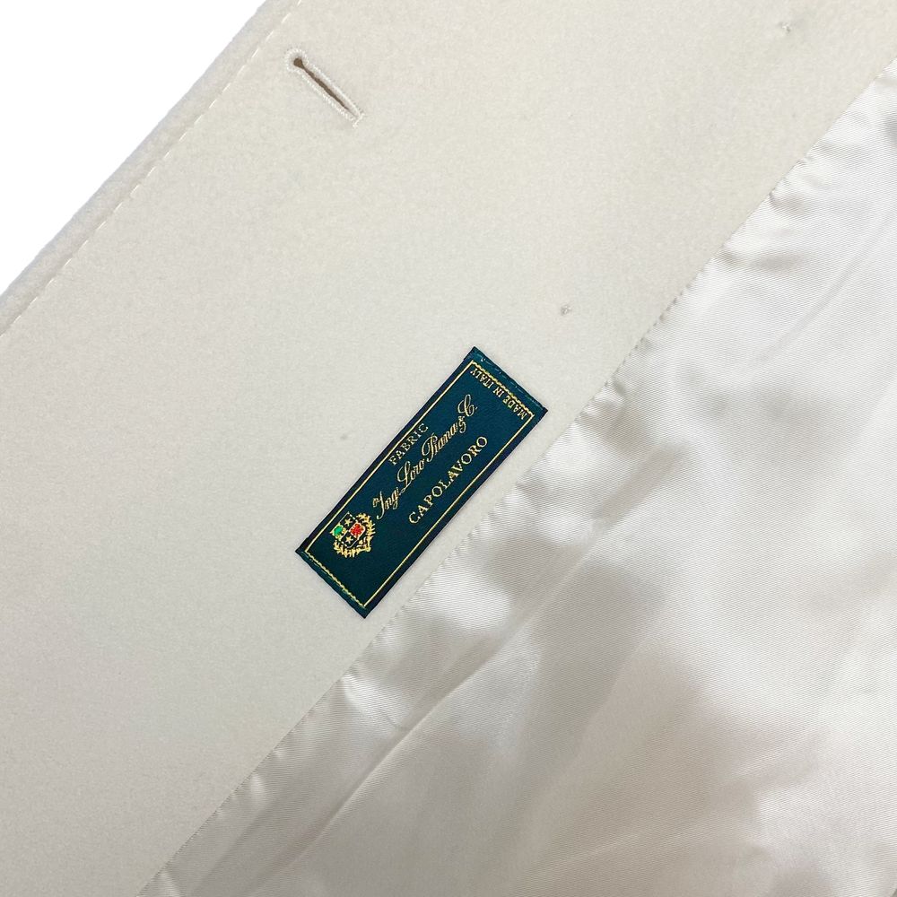Label inside Made in Italy White Wool Women Coat, featuring Loro Piana fabric, displays expertise and luxury craftsmanship.