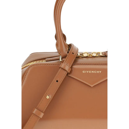 Close-up of Givenchy Brown Calf Leather Bos Taurus Handbag with embossed signature and articulated leather handle.