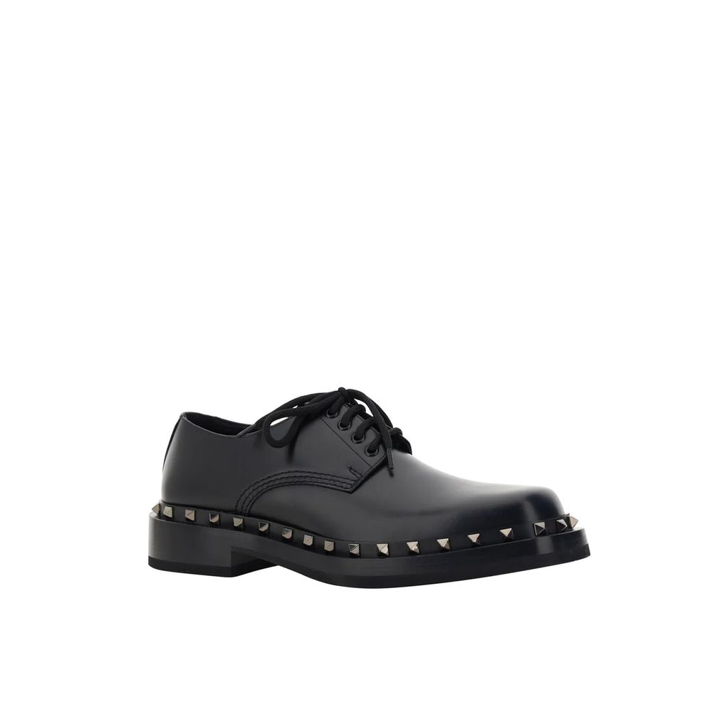 Valentino Garavani Black Calfskin Oxfords And Derbies with studs detail, round toe, front lace-up closure, made in Italy.