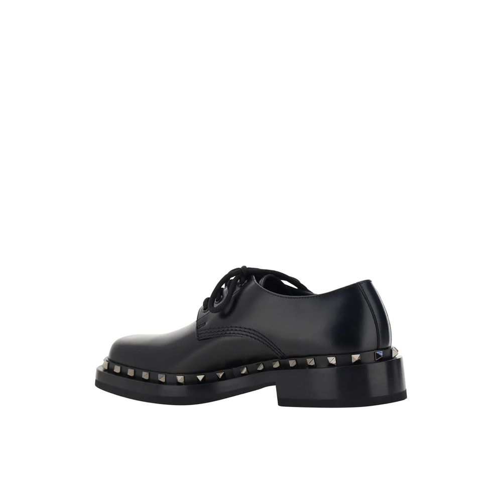 Valentino Garavani Black Calfskin Oxfords And Derbies with studs detail, round toe, leather composition, and lace-up closure.
