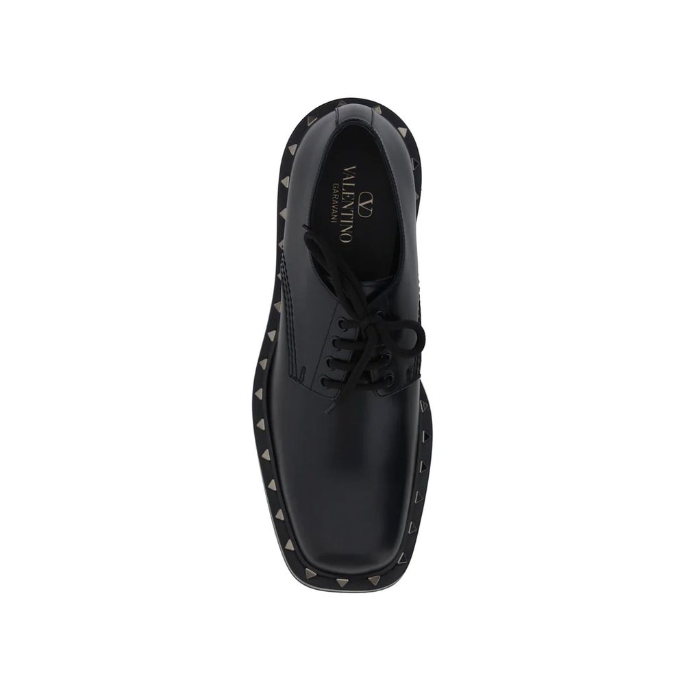 Valentino Garavani Black Calfskin Oxfords And Derbies with studs detail and lace-up closure made in Italy for men.