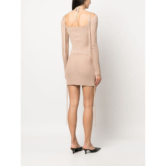 Back view of model wearing ribbed-knit mini dress, semi-sheer panels, ANDREĀDAMO Andrea Adamo Dresses Beige, halterneck tie, square open back.