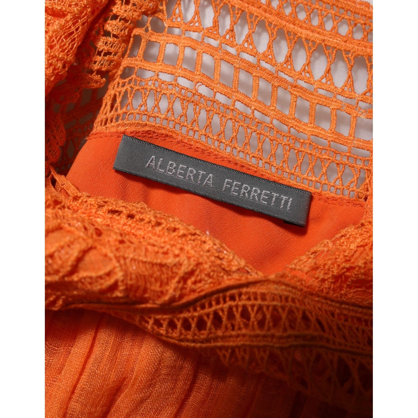 Close-up of label on Alberta Ferretti Orange Lace Bustier Layered Maxi Dress, featuring intricate lace details.