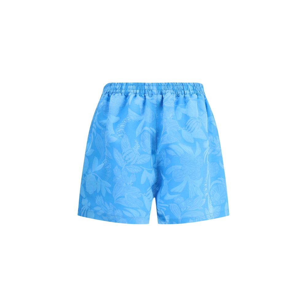 Balenciaga Blue Viscose Bermuda Shorts with floral print, elastic waistband, and side welt pockets for a bold summer look.