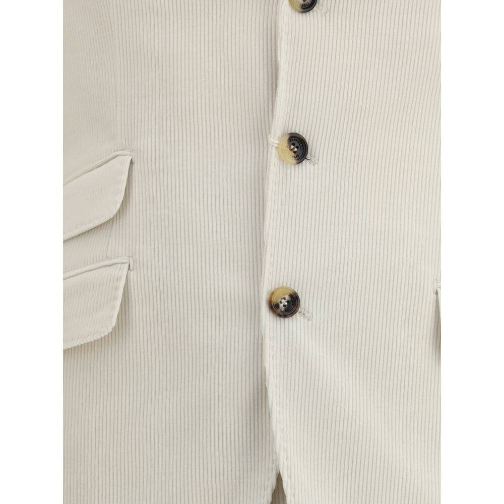 Close-up of Brunello Cucinelli Cream Cotton Two-Piece Suit jacket with button details and flap welt pocket.