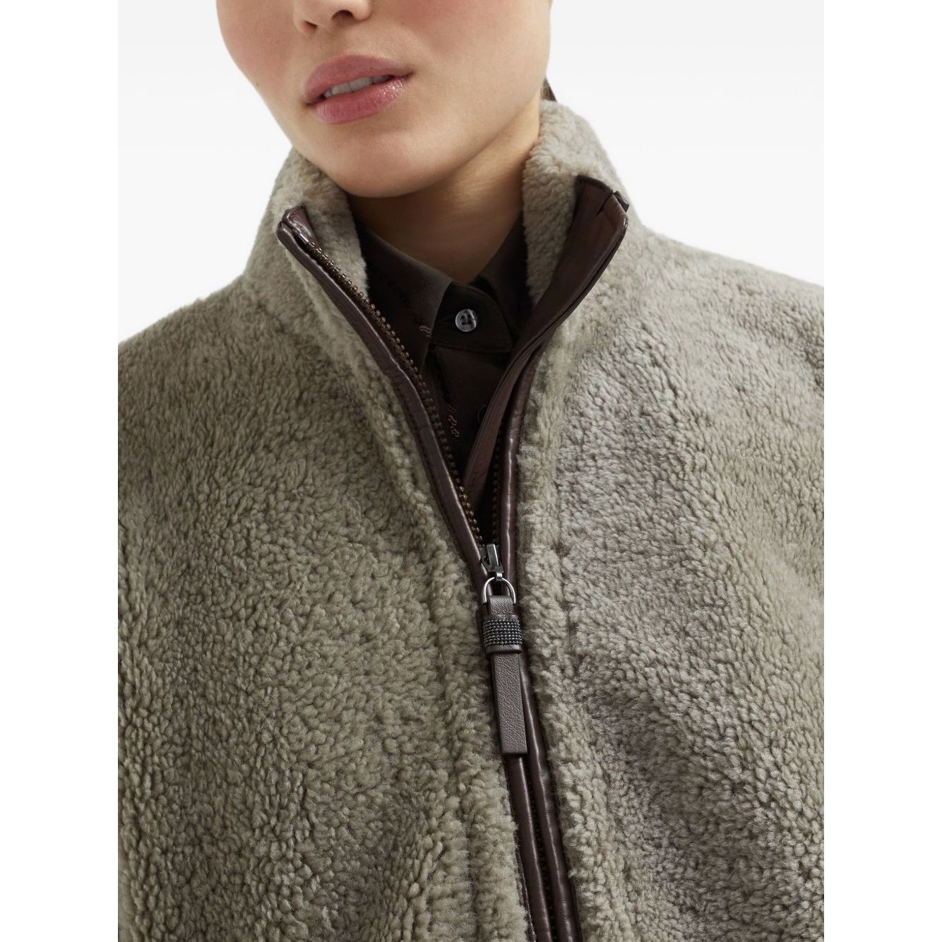 Woman wearing Brunello Cucinelli Curly Shearling Short Sleeve Outerwear with Shiny Zipper Pull, close-up view of the texture and zipper.