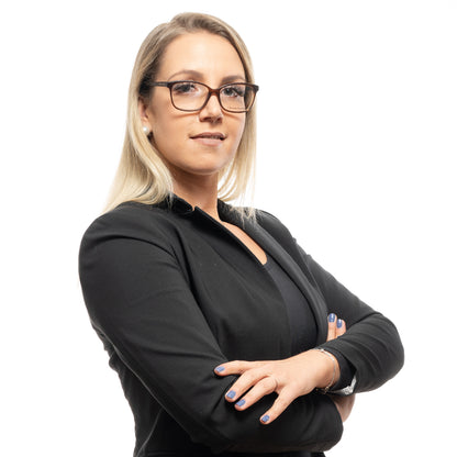 Woman wearing CHRISTIAN LACROIX MOD. CL1093 53155 optical frame for ladies made of acetate, arms crossed, against white background.