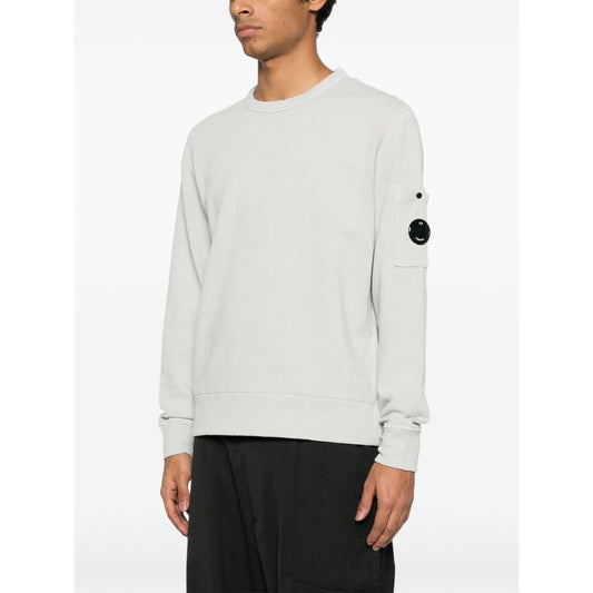 C.P. COMPANY Sweaters Clear Blue crew neck sweatshirt with sleeve patch pocket and ribbed cuffs shown on model