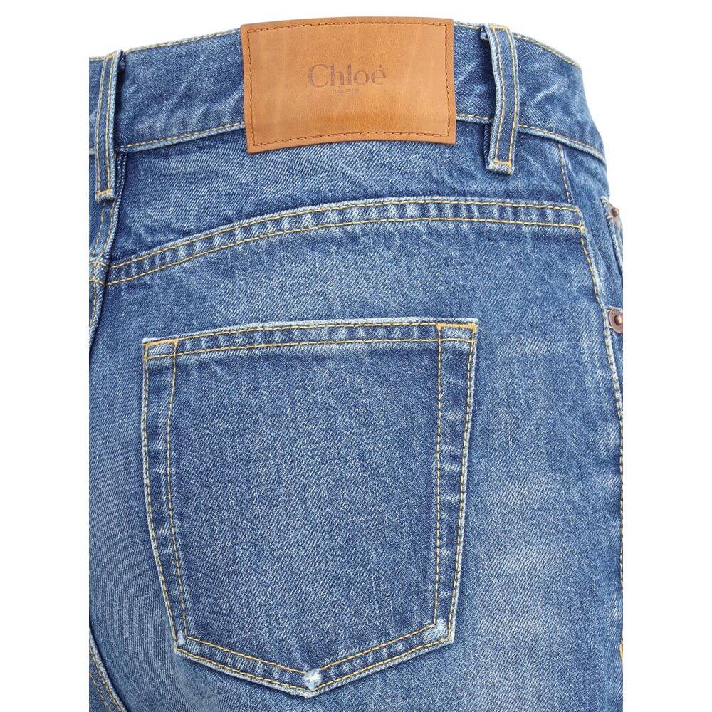 Rear view of Chloé Blue Cotton Flared Jeans showcasing classic five-pocket design and leather label, perfect for modern styling.