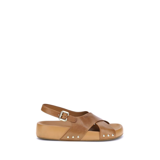 Chloé Mae Sandals in brown calfskin with gold studs, featuring crossed straps, iconic Paddington buckle, and embossed Chloé logo.