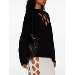 Woman carrying Chloé Small Bracelet Hobo Bag in black calf leather with gold-tone hardware and detachable shoulder strap.