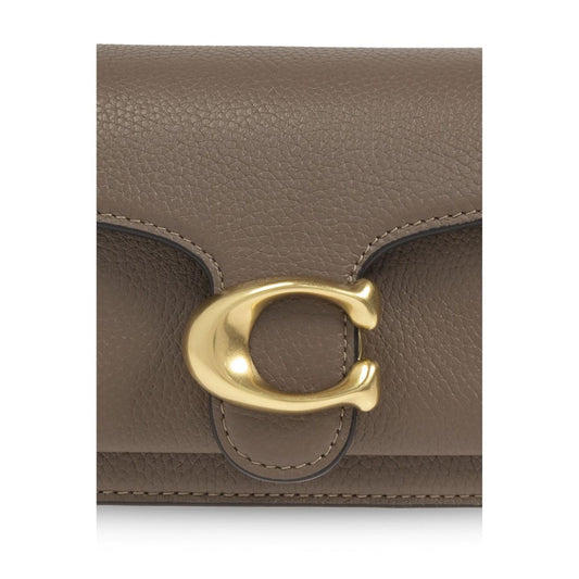 Front view of Coach Tabby 20 shoulder bag flap with gold hardware detail.