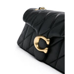 Coach Tabby shoulder bag in black quilted leather with gold-tone logo plaque, featuring a push-lock fastening and chain-link strap.