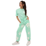 Comme Des Fuckdown Green Cotton Jeans & Pant with floral print, elastic waistband, and drawstring. Casual streetwear fashion style.