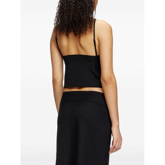 Rear view of model wearing Diesel Top Black, a wool blend halterneck with adjustable straps and cropped straight hem.