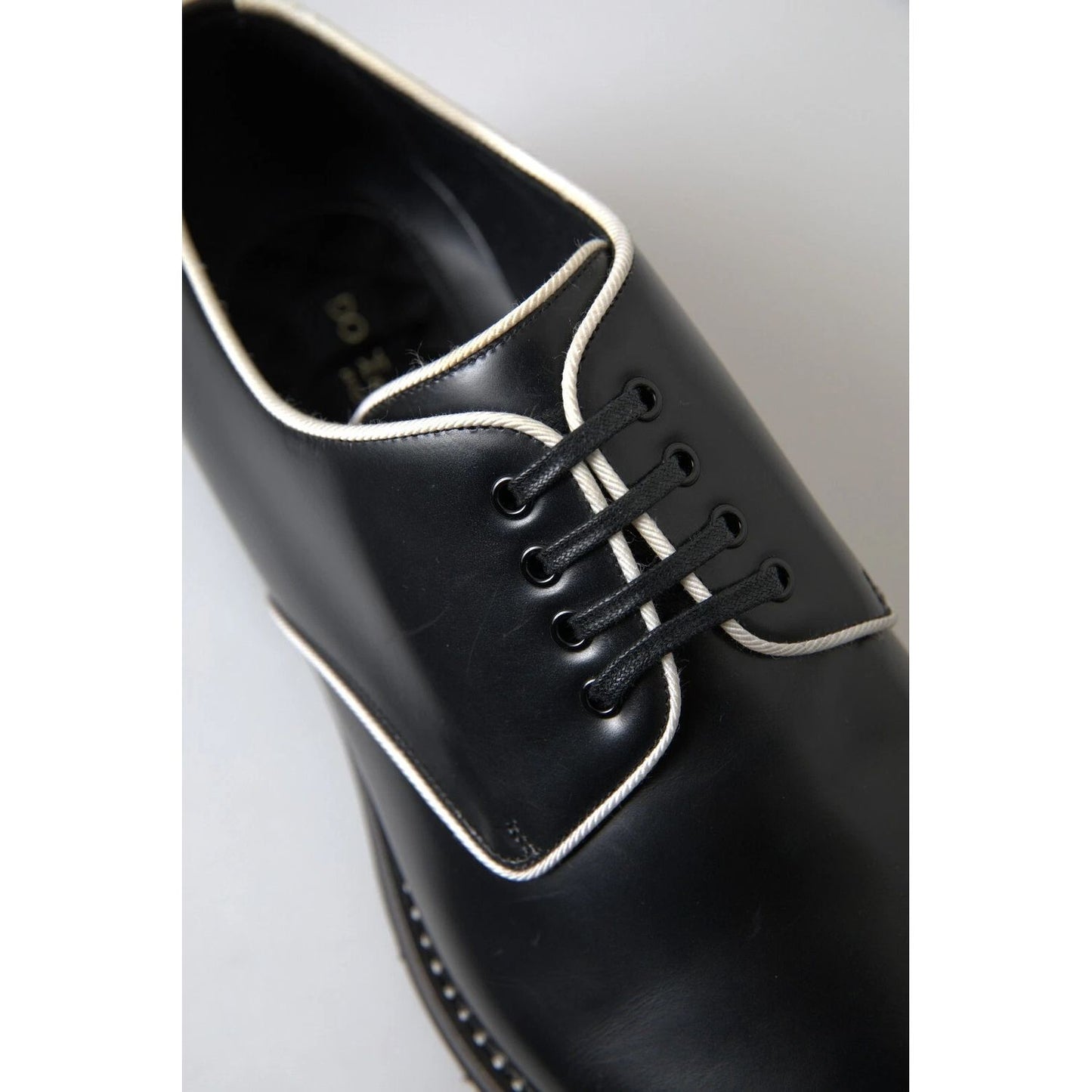 Dolce & Gabbana Black White Leather Formal Dress Shoes with logo detail, made in Italy, showing high craftsmanship and exclusive design.