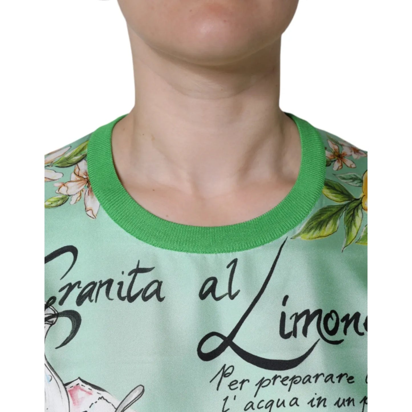 Close-up of Dolce & Gabbana Green Lemon Print Pullover Silk Women Sweater showcasing Granita al Limone print with flowers and text.