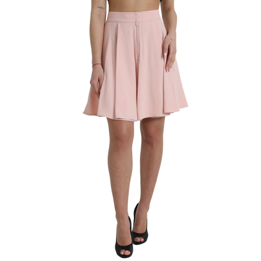 Model wearing Dolce & Gabbana Light Powder Rose Viscose Pleated Skirt with high waist and flared design, crafted in Italy.
