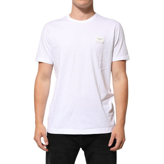 Model wearing Dolce & Gabbana White Logo Plaque Cotton Crew Neck T-shirt with logo patch visible on chest.