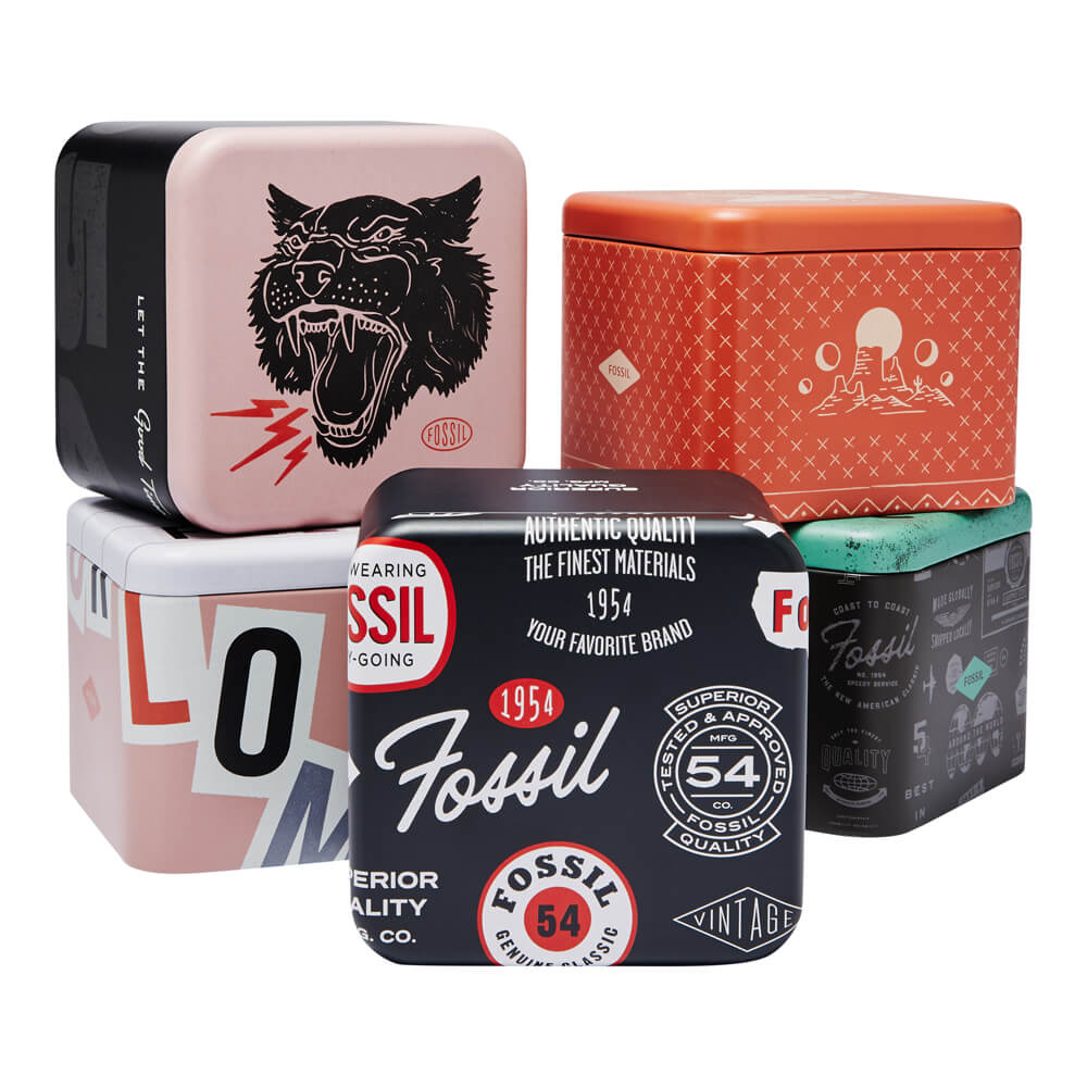 Stack of colorful Fossil wristwatch packaging boxes with vintage designs, highlighting the FOSSIL Mod. ES5137 product.