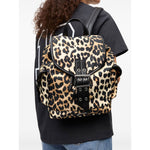 Person carrying Ganni Leopard Small Nylon Bucky Backpack featuring buckle fastening and drawstring closure.