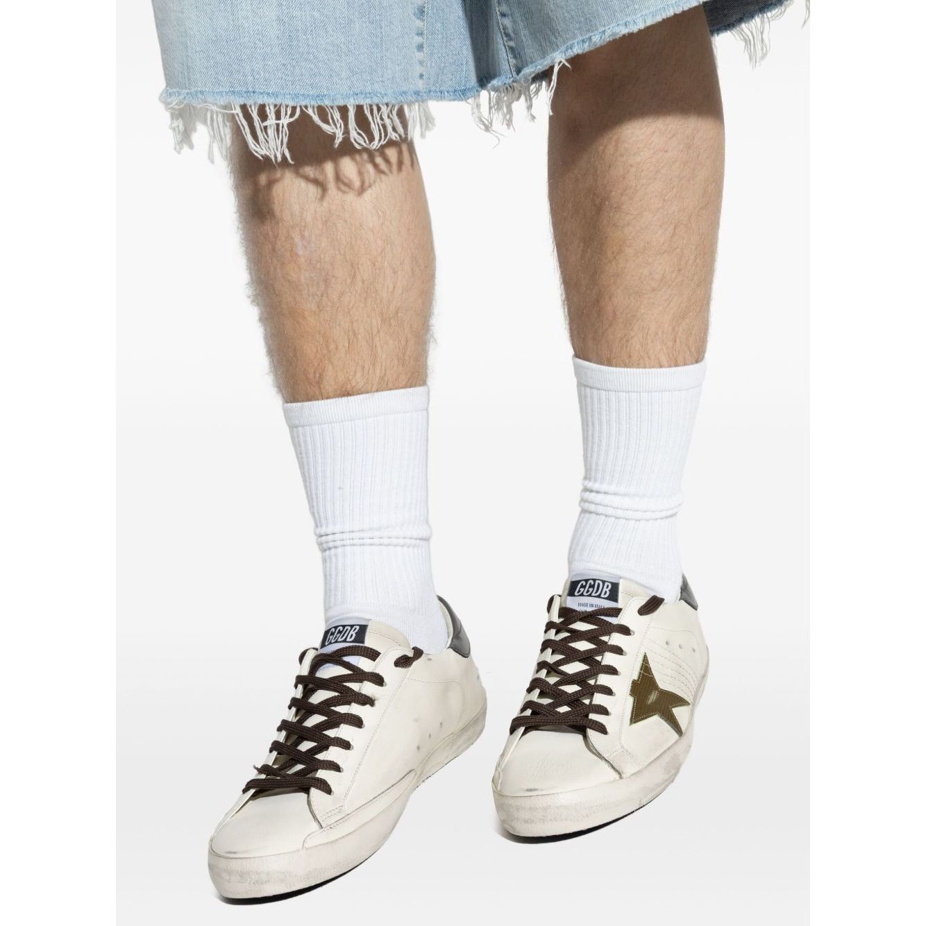 Golden Goose Super-Star in nappa leather with leather star and leather heel tab, white sneakers with star patch and contrasting heel.