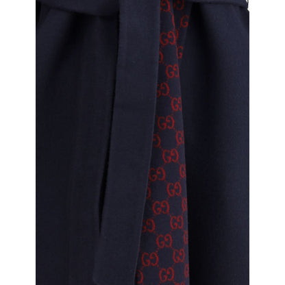 Gucci Blue Wool Coat with monogram inner panel and removable sash, showcasing luxury fashion details.