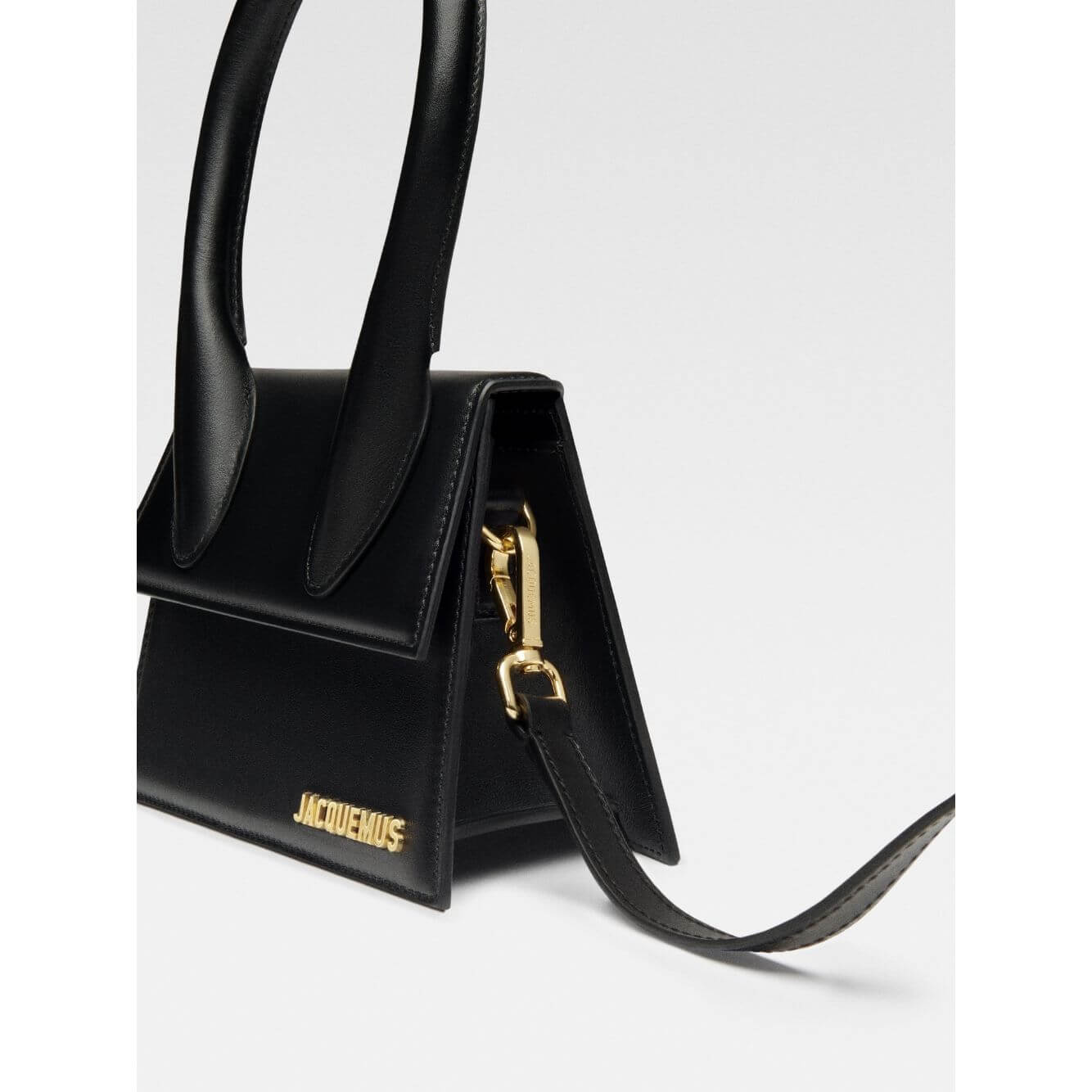 Jacquemus Le Chiquito Moyen Black Bag with gold hardware, showing reinforced handle and detachable strap, stylish designer accessory.